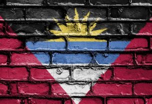 The flag of Antigua and Barbuda painted on a brick wall