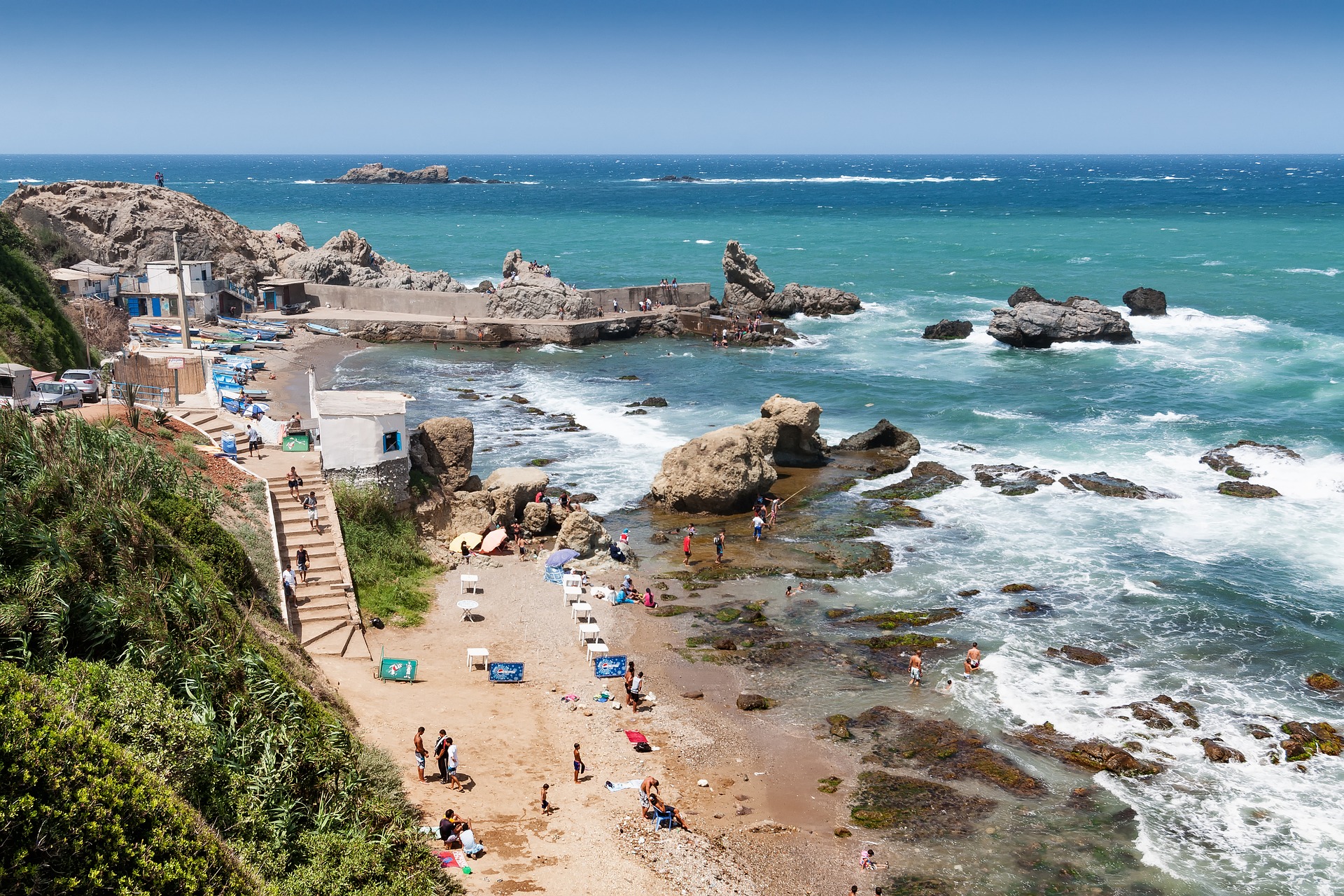 Algerian coast with a view on the Mediterranean and people on the beach.