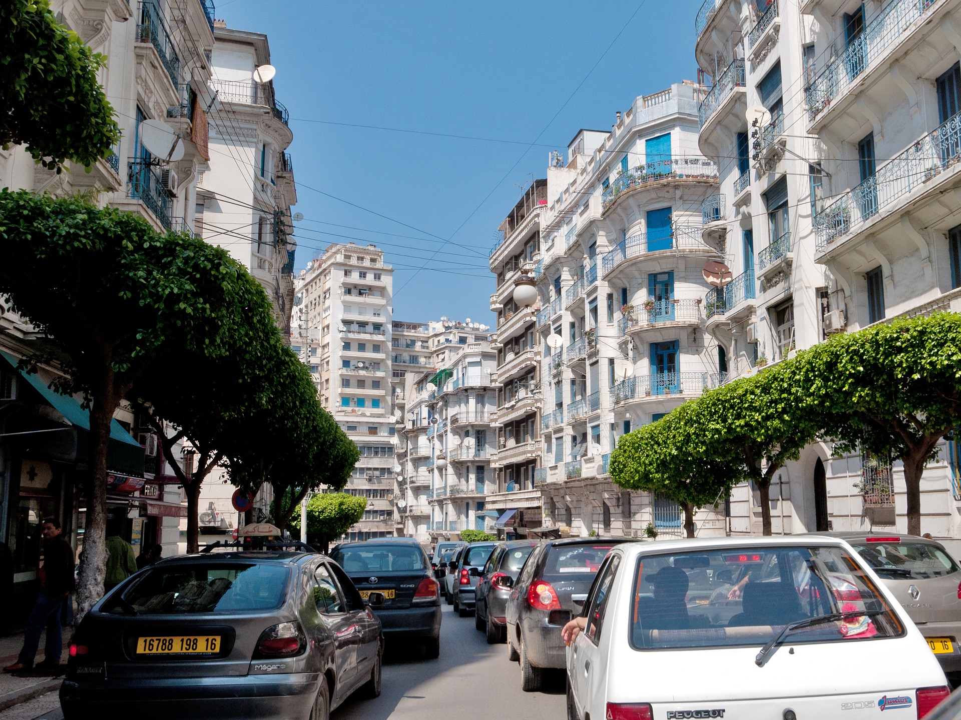 Street view with high blocks overlooking pedestrians and vehicles