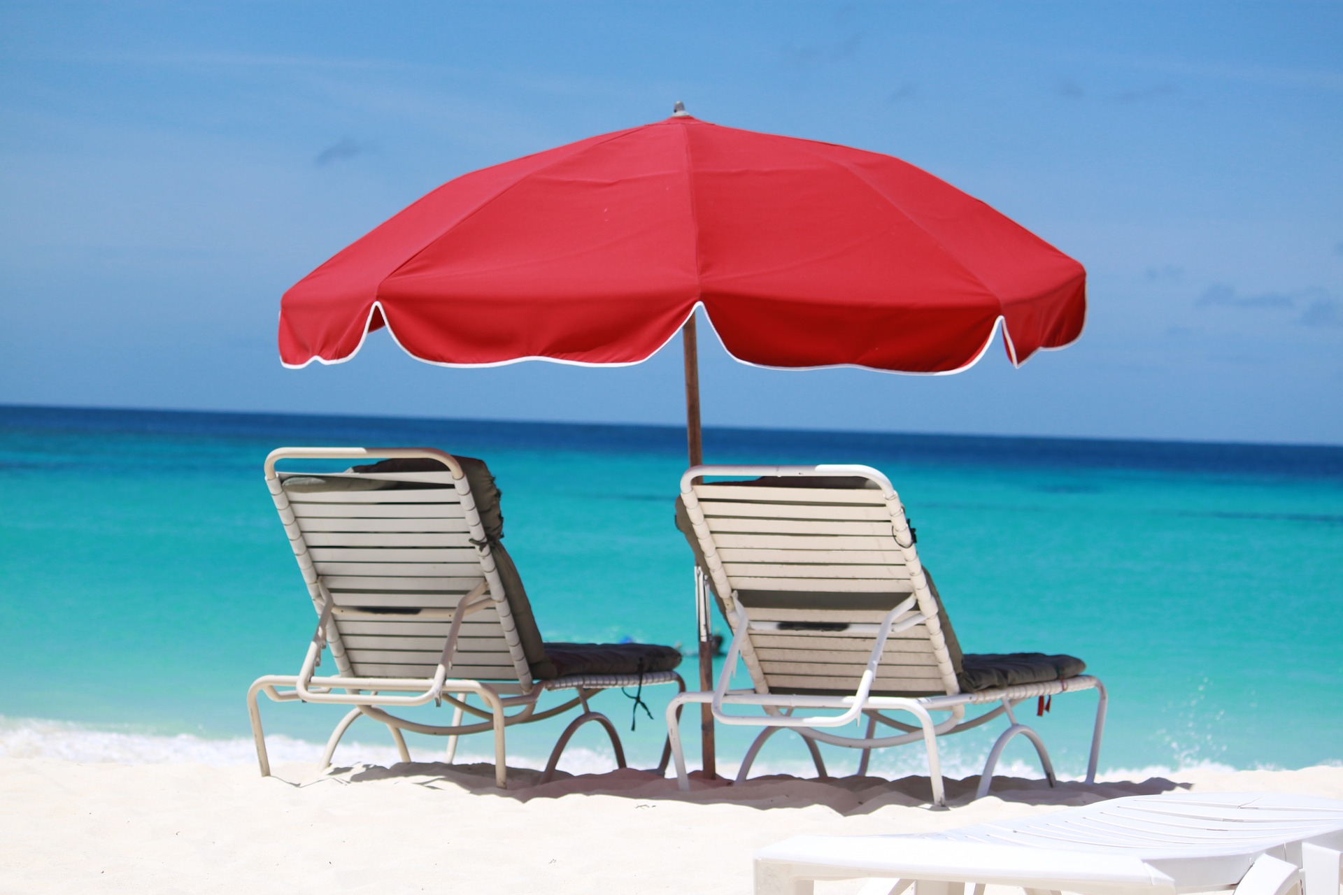 Chairs on a beach in Anguilla, turquoise Caribbean water