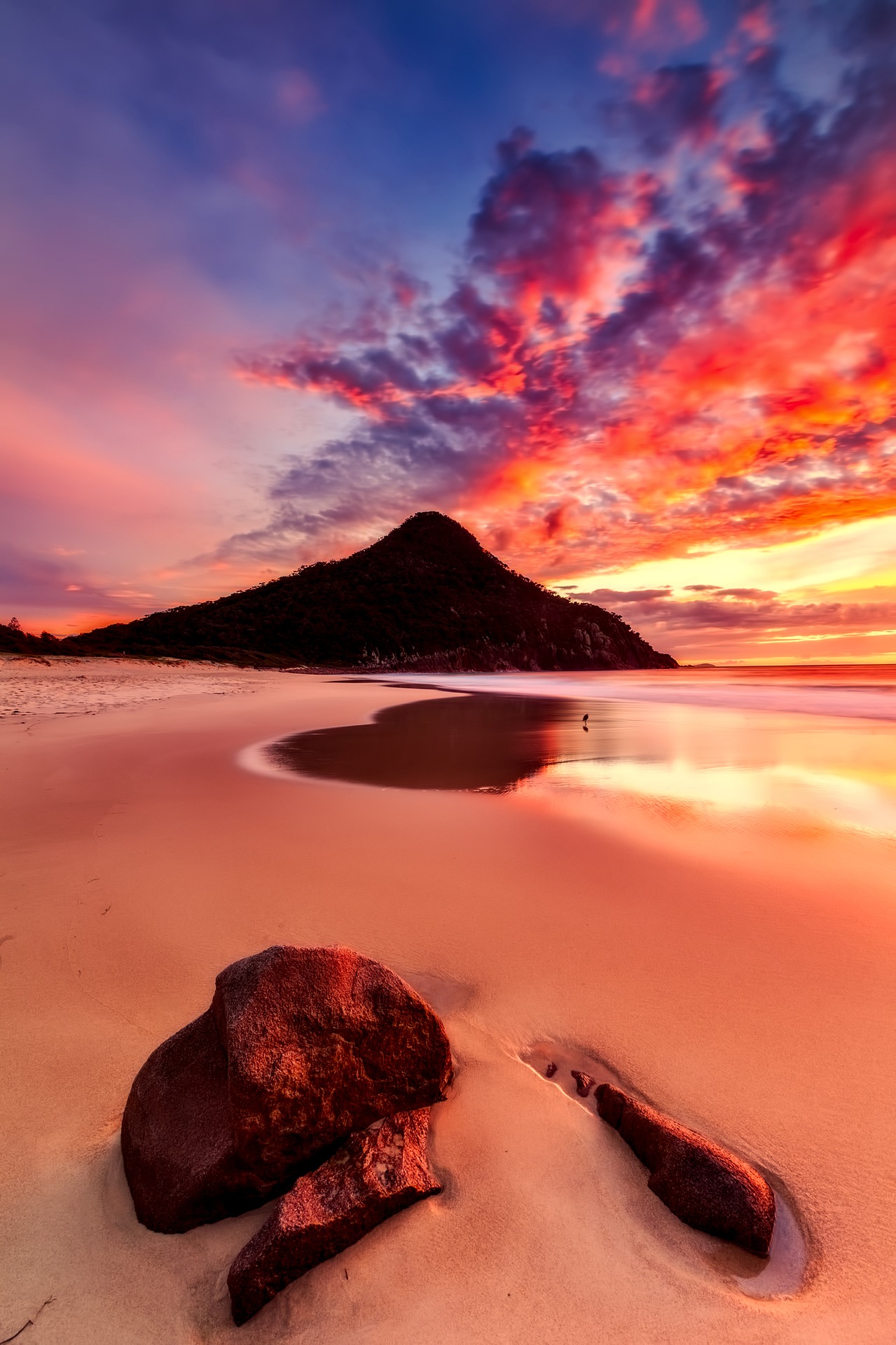 Sunset on an Australian beach with a mountain in the distance