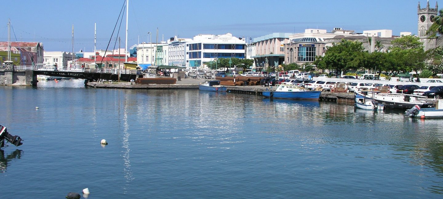 A harbor in barbados with boats and buildings in the background