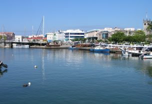A harbor in barbados with boats and buildings in the background