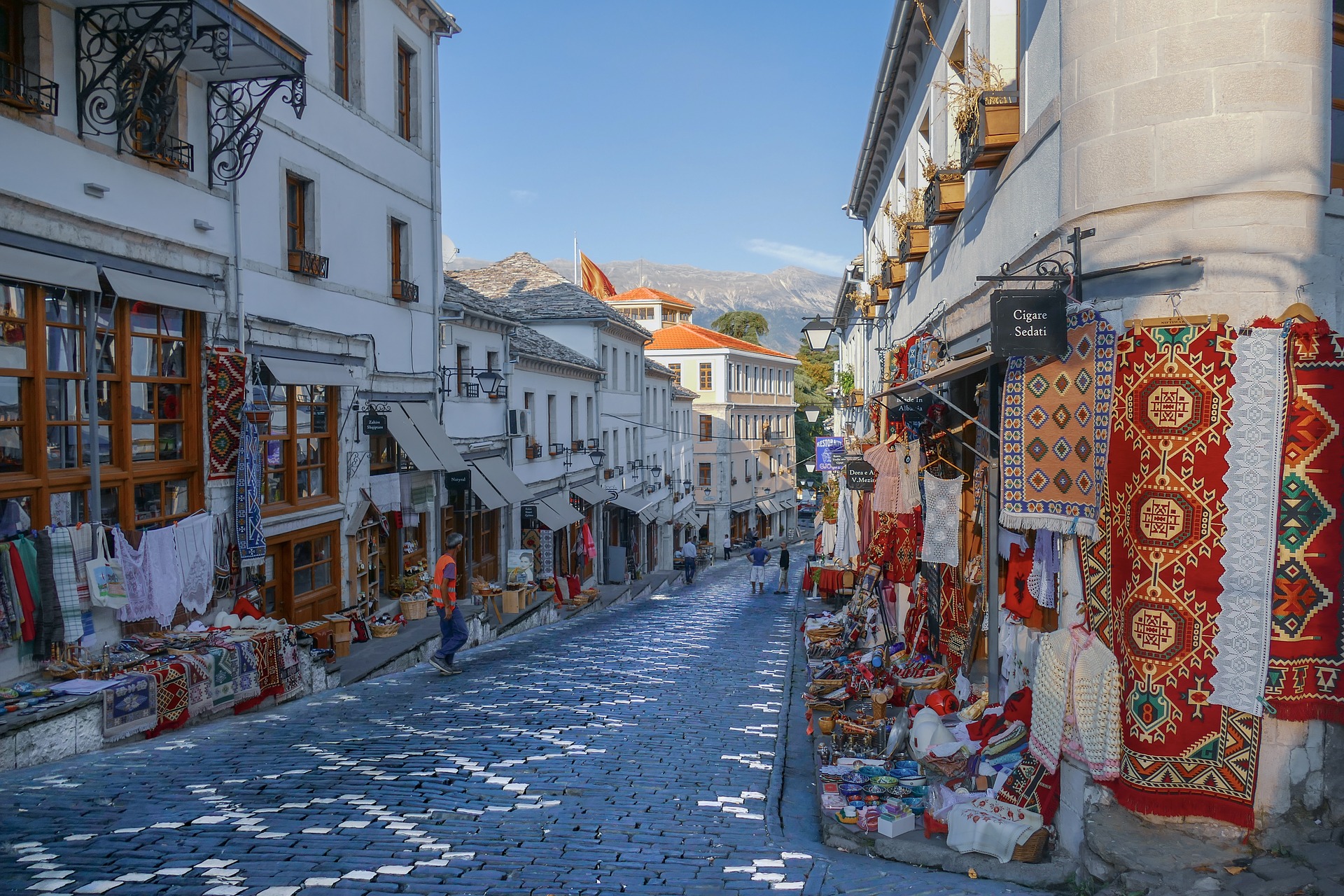 Cobblestone road with shops on both sides selling homemade wares