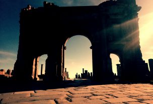 Sunset setting on Ruins of Roman arch in Algerian desert