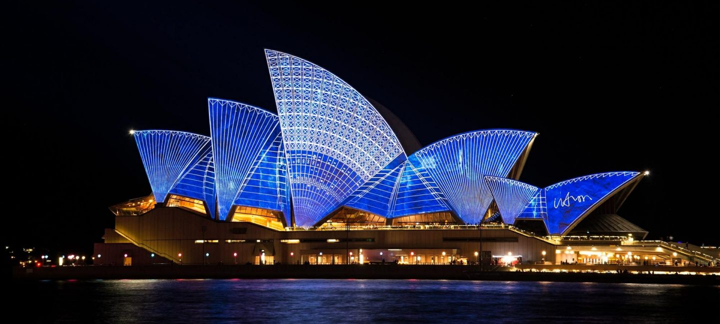Sydney opera house lit up at night