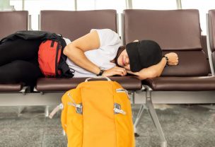 The woman is sleeping in airport terminal and waiting for airplane arrival; delayed aeroplane concept.