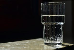 Glass of water standing on a marble table