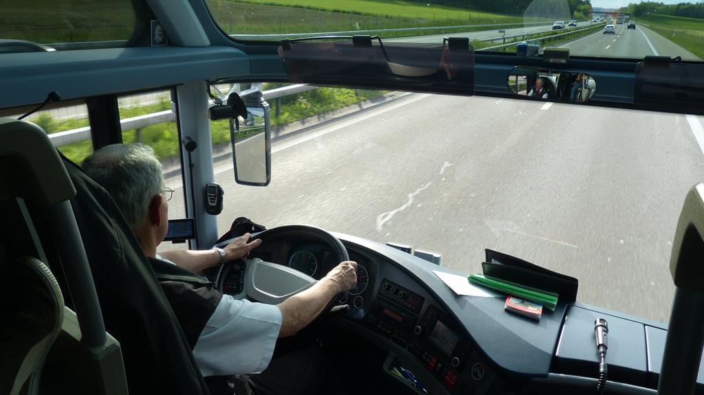 Image of a bus driver driving his bus